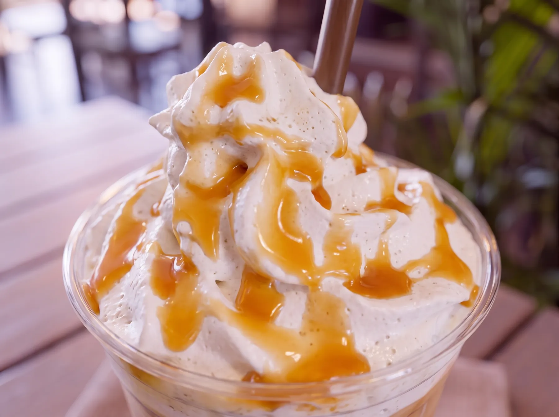 A caramel frappe under whipped cream.