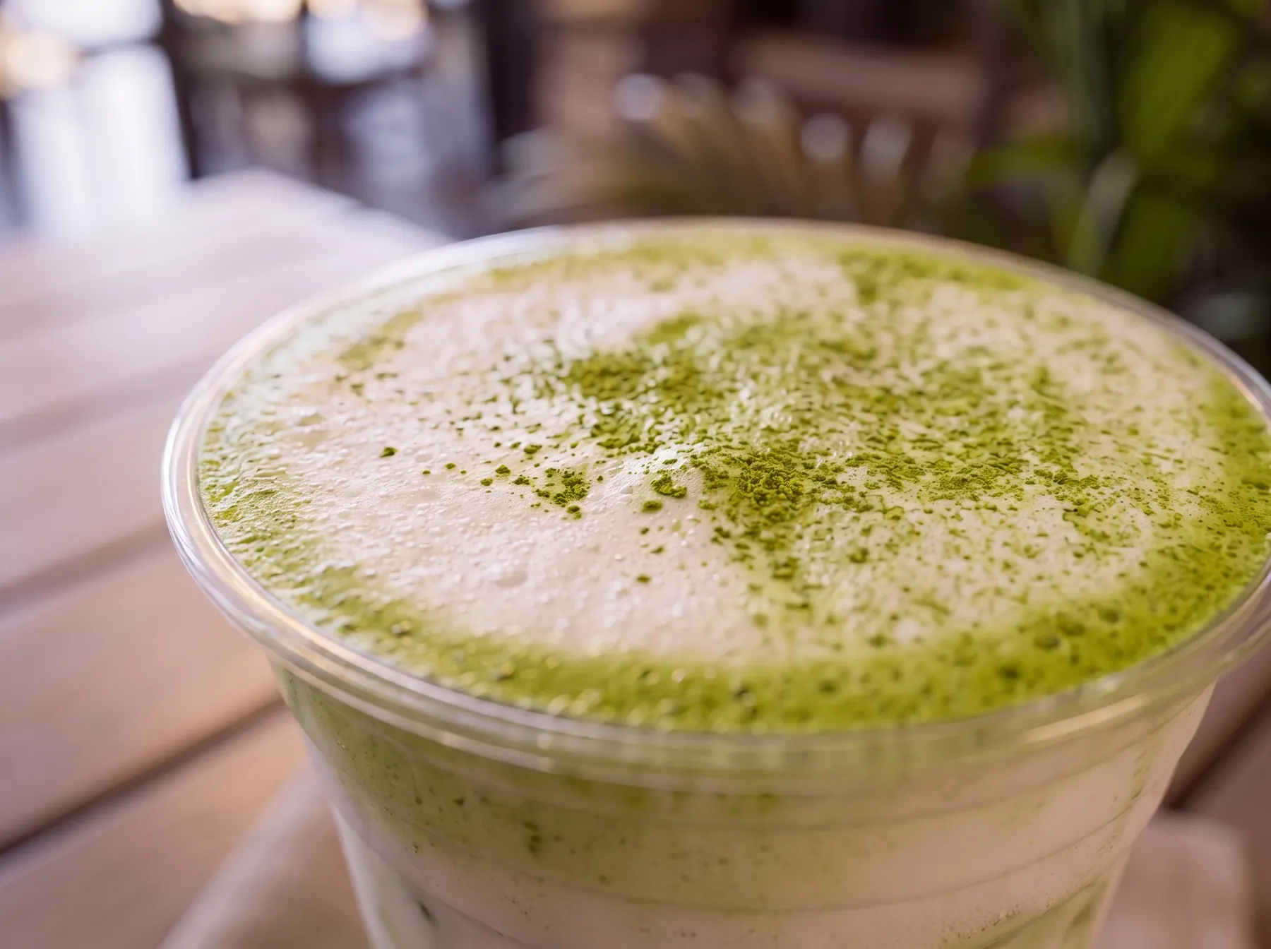 An iced matcha latte dusted green on top.